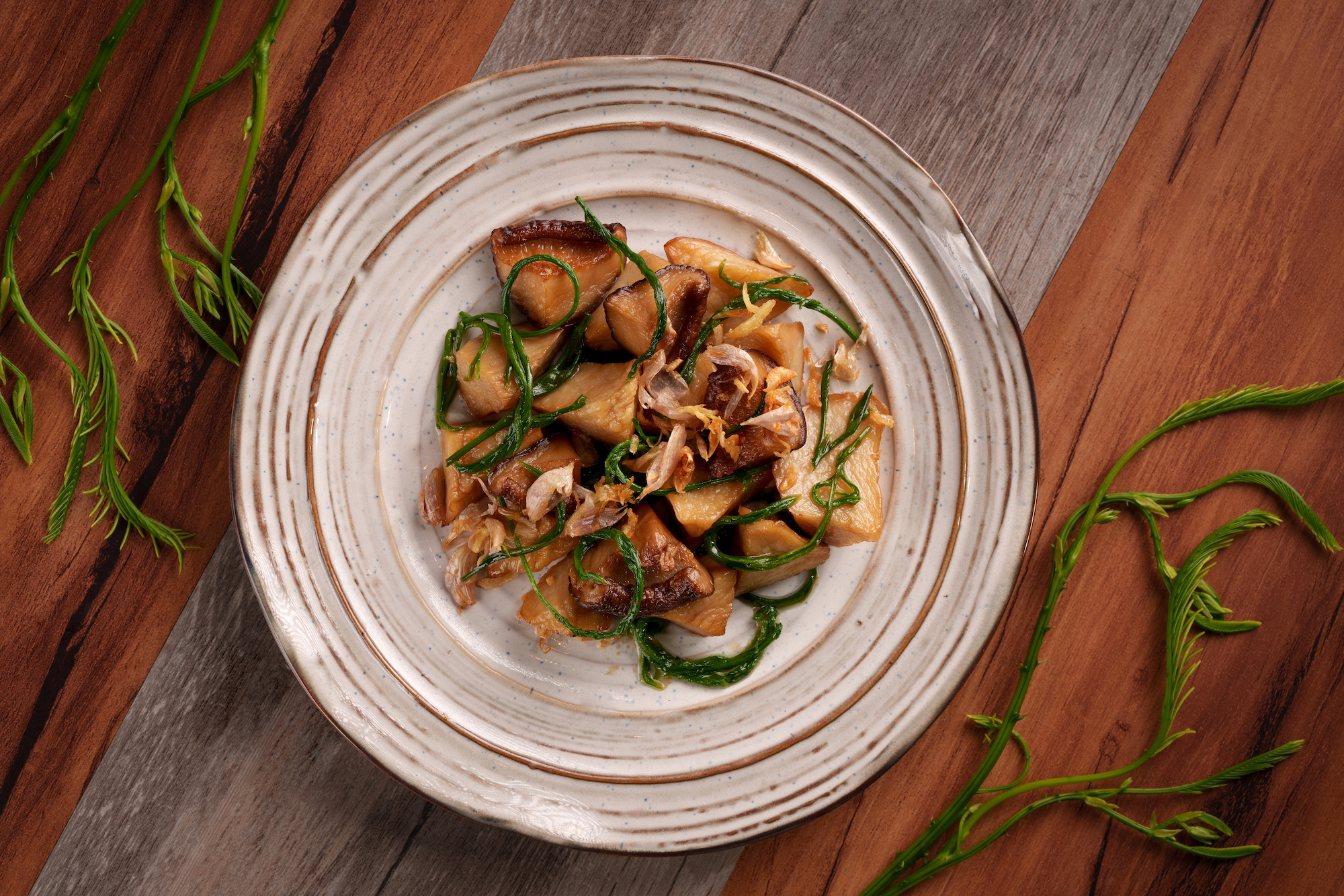 Hearty mushrooms stir-fried with cha-om, or Thai acacia leaves – ‘comfort food’ that Ruangnukulkit adapted from her mother’s recipe