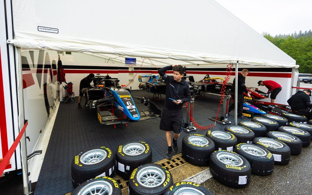 Formula Regional vehicles parked in their respective garages prior to the Formula Regional European Championship